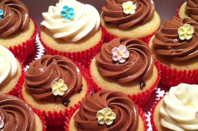 Chocolate chip cupcakes covered with vanilla or chocolate buttercream topped with edible sugar flower