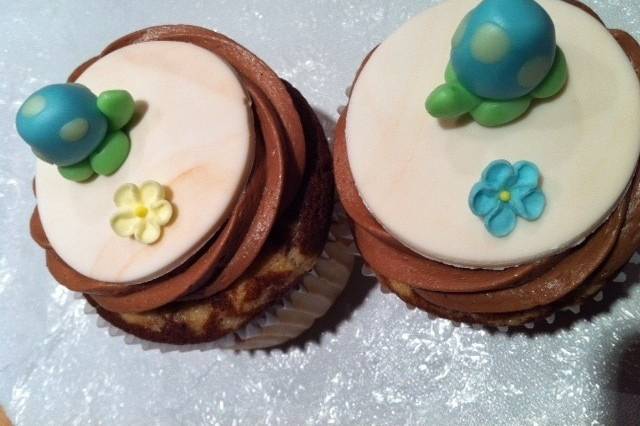 Aren't these cute!  Handmade tiny turtles from fondant sitting on fondant disc with edible sugar flower