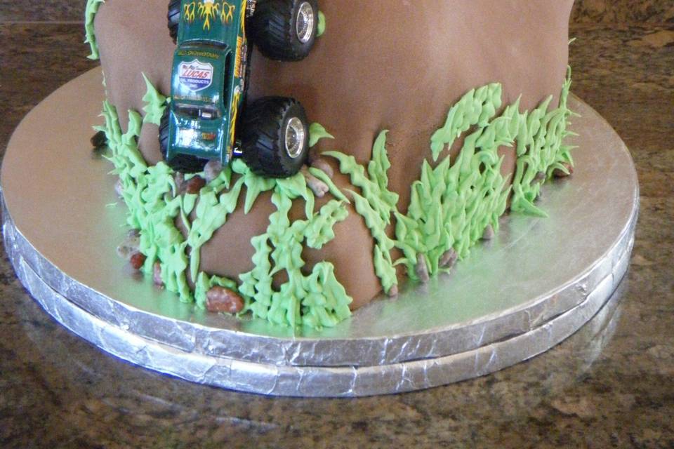 Chocolate devils food 4 wheel drive mountain decorated with leaves and monster trucks