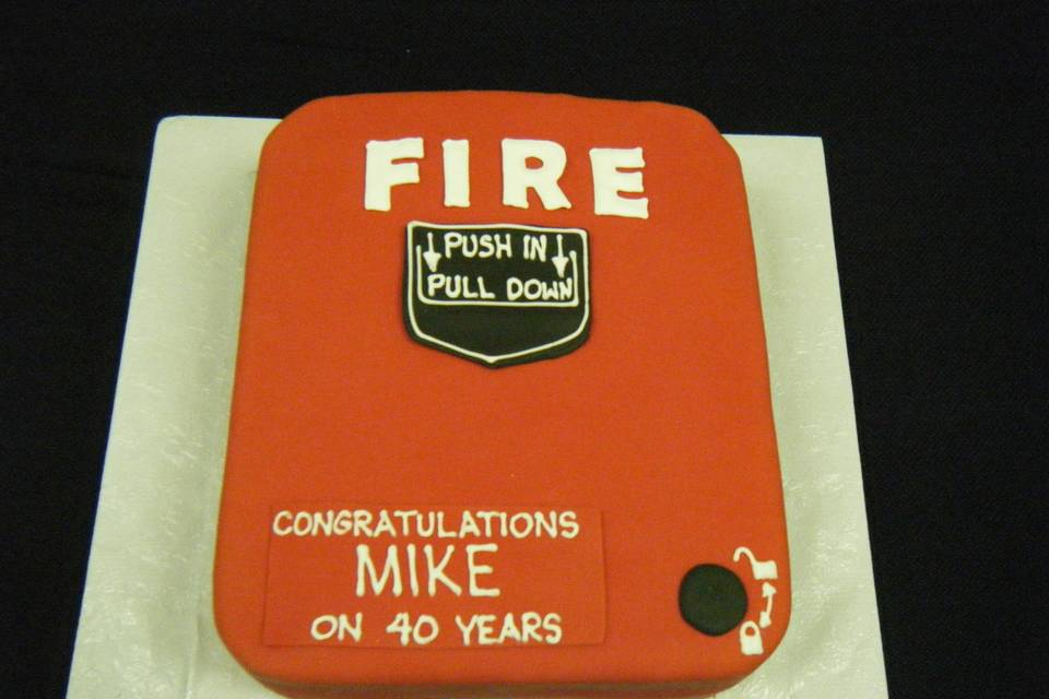 Carrot cake covered in fondant to replicate a fire alarm