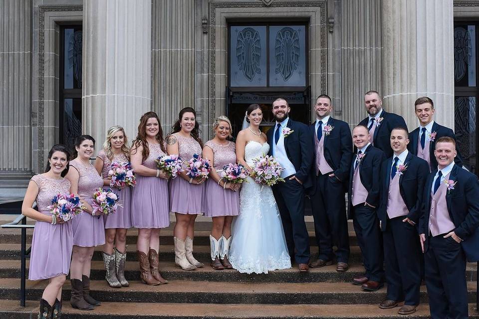 The couple with their groomsmen and bridesmaids