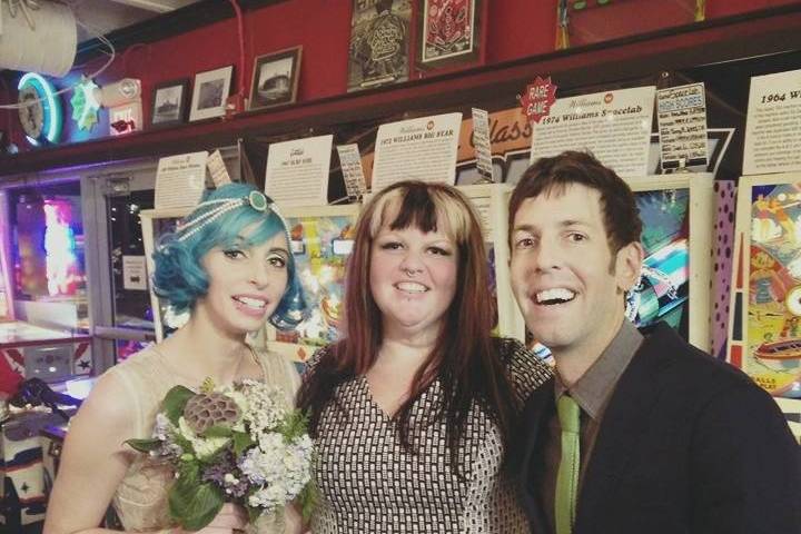 Happy couple with the officiant