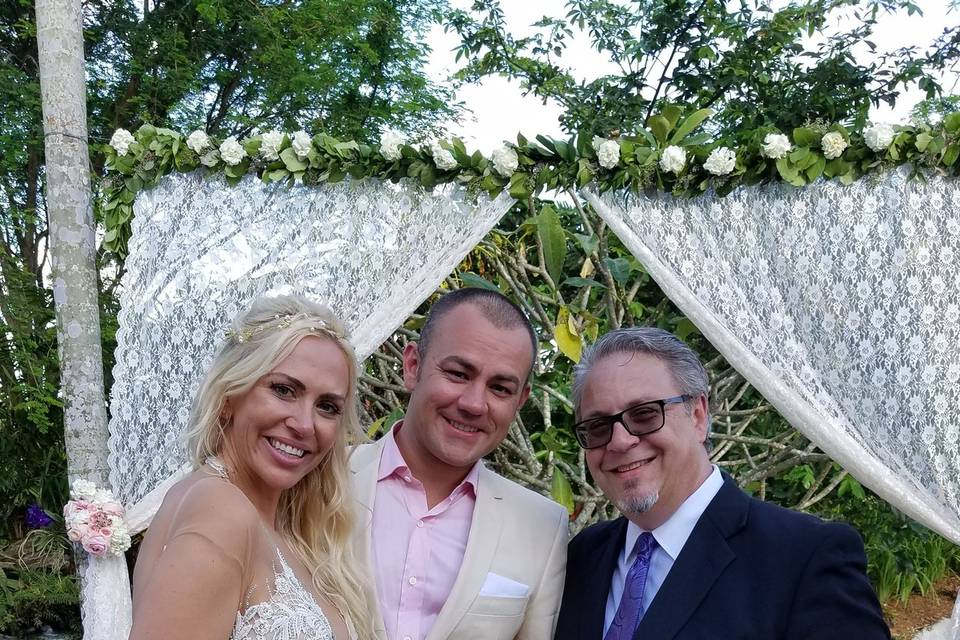 Bride and groom with their wedding officiant