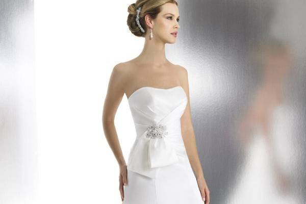 Style T523 is a luxurious satin trumpet. The drop waist is accented with a bow and beaded detailing.
