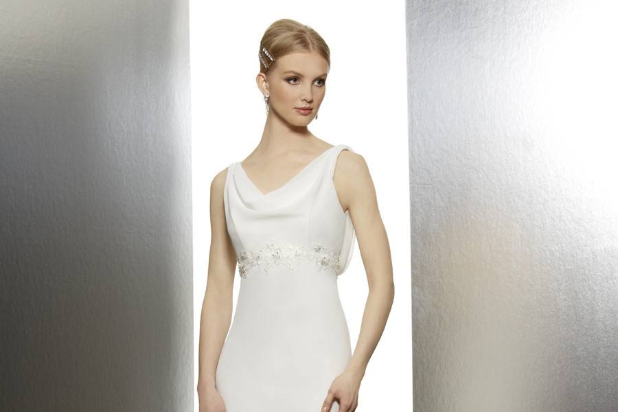 T 598Fall 2013This chiffon sheath has a soft cowl neckline that dramatically dips into a deep cowl back. Re-embroidered schiffli lace appliques adorn the empire waist, creating a flattering effect.
