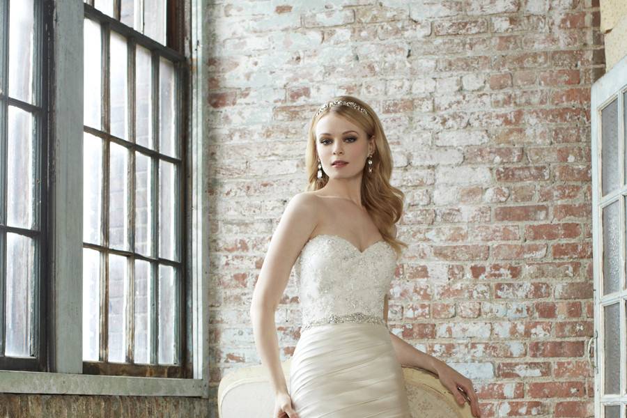 J 6278Fall 2013A luxurious new fabric, duchess satin, is pleated into this form fitting mermaid with soft pick-ups. An ornately hand-beaded bodice features Swarovski detail and a beaded sash that accentuates the waist.