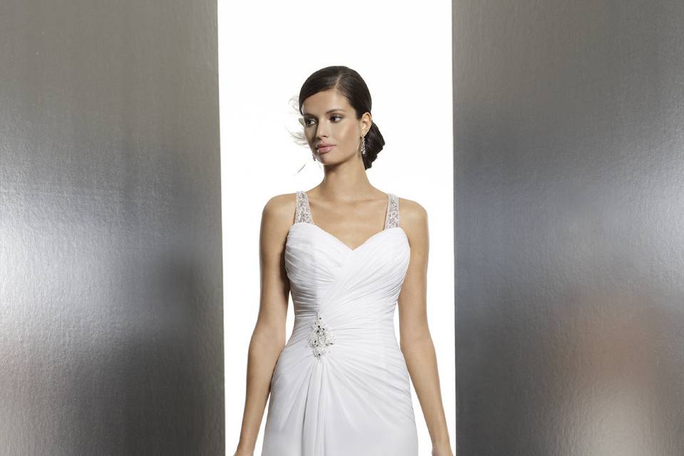 T628Asymmetrical cross-ruching forms this spectacular sheath with a Swarovski encrusted, racer back and detachable straps. The neckline dips into a sweetheart with an accenting motif at the hip.
