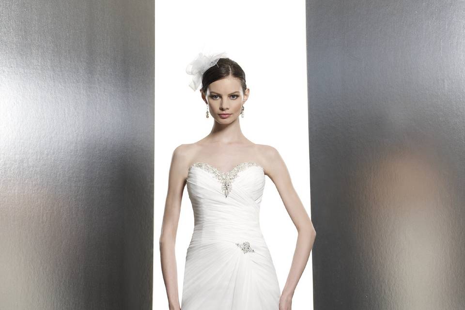 T631This chiffon trumpet features flattering micro-pleats across the bodice. Swarovski crystals accent the sweetheart neckline and a corset closure ties this look together.