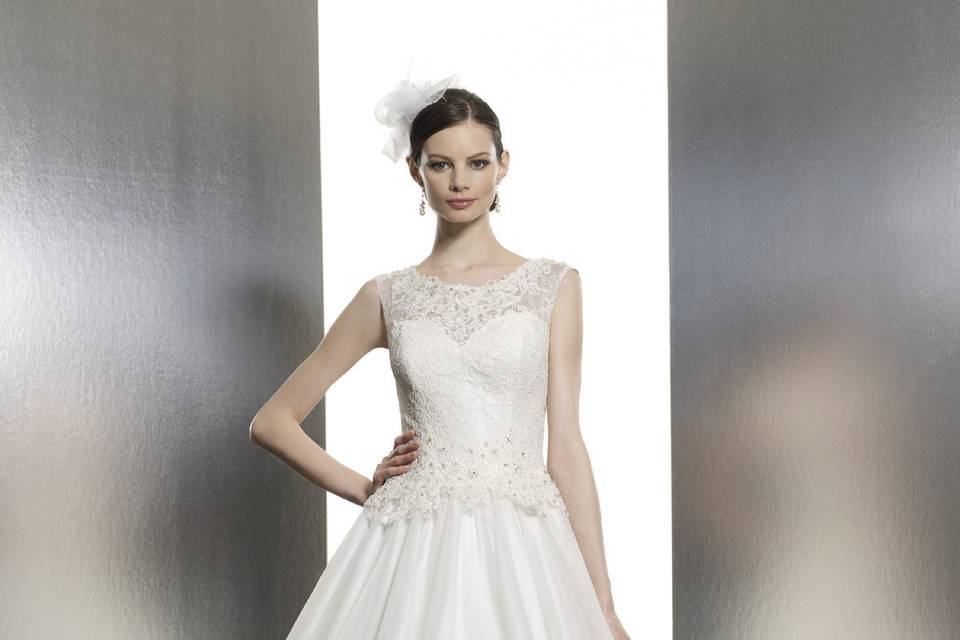 T636A rich satin ball gown with alencon lace and beaded accents along the sheer bateau neckline and bodice.