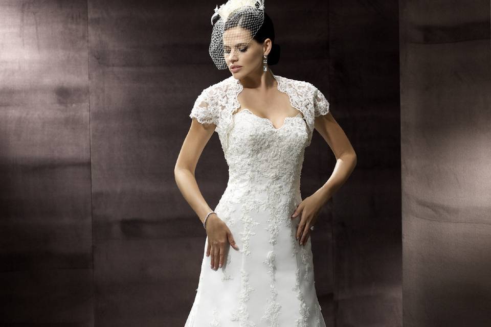 Moonlight CollectionJ6299Lace is draped over net to create this trumpet style. The sweetheart neckline has scalloped edging and embroidery throughout. The corded lace jacket is optional. 