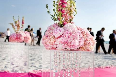 Crystal pedestals held pillows of sara bernard peonies with california larkpsur and more as they lined the aisle