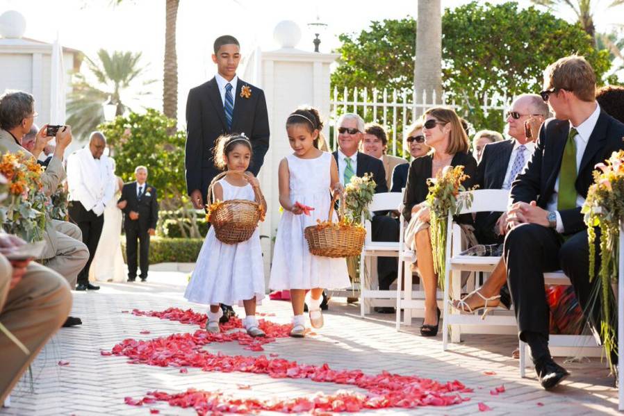 Flower girls on petal scrolled aisle