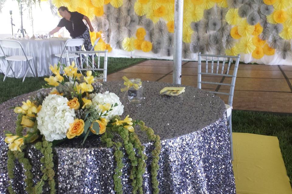 Sweetheart table infront of paper detail wall