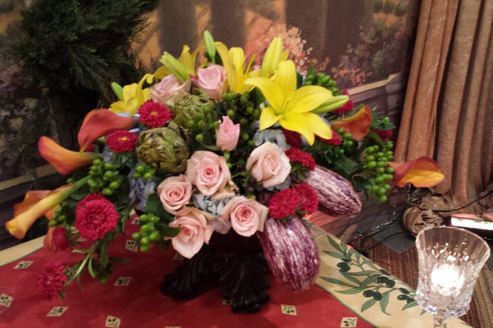 Vegative centerpiece featuring artichokes and japanese eggplant