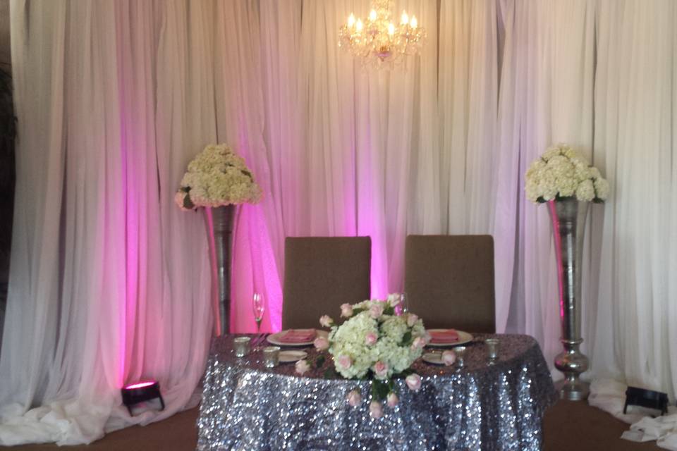 Sweetheart table golden ocala, draping, lighting, linens and floral
