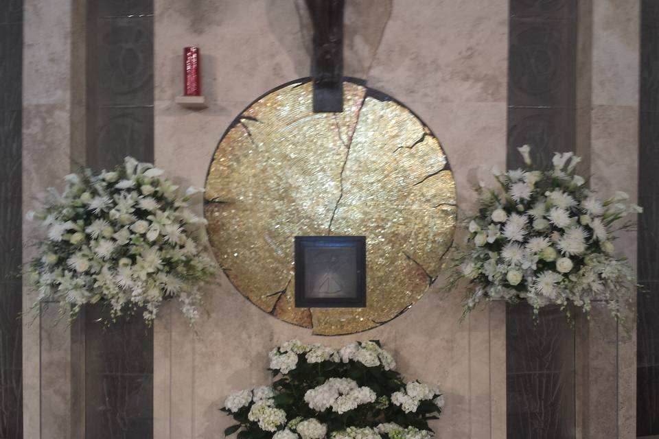 Queen of peace altar flowers atop lucite columns