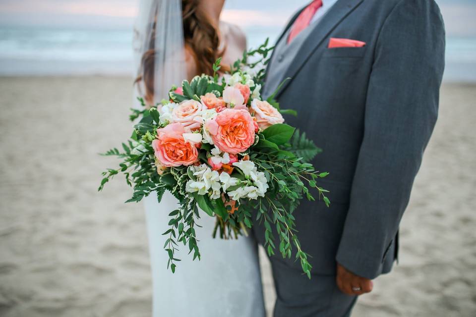 Newlyweds behind their bouquet