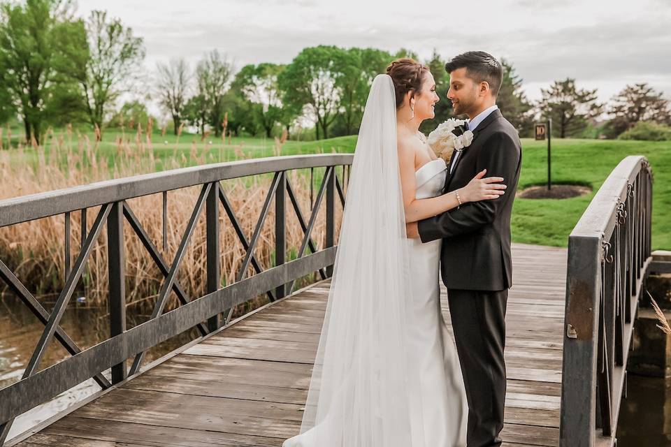 Bride and groom on bridge