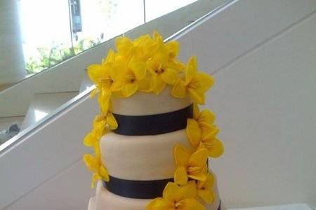 Dairy free wedding cake covered in rolled buttercream and adorned with open tulips
