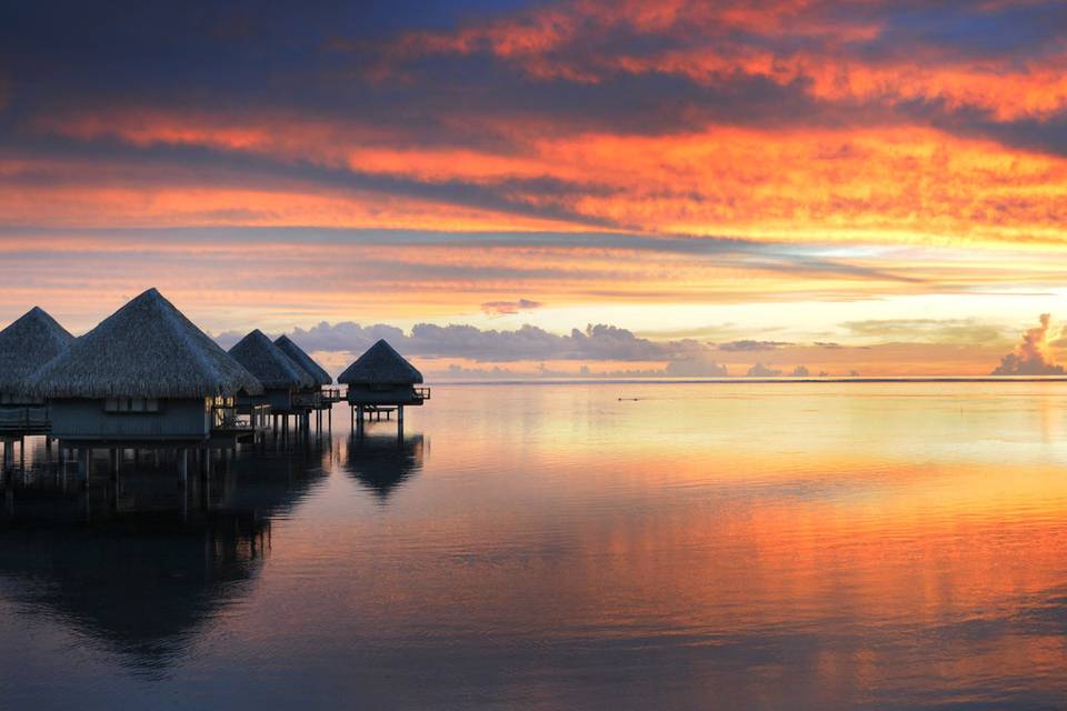 Sunset from an overwater bungalow set the mood for a romantic evening | Honeymoons by Tahiti.com