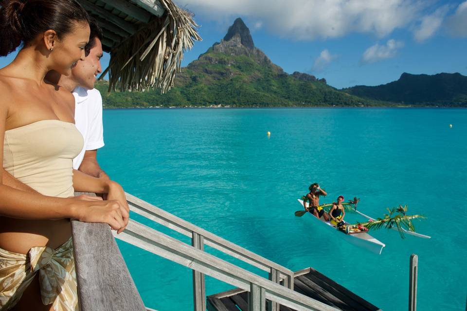 Enjoy breakfast delivered by outrigger canoe to the terrace of your overwater bungalow | Honeymoons by Tahiti.com