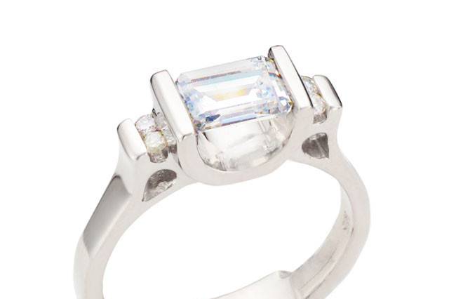 Emerald Cut diamond ring with round diamond accents designed by Spectrum Art & Jewelry