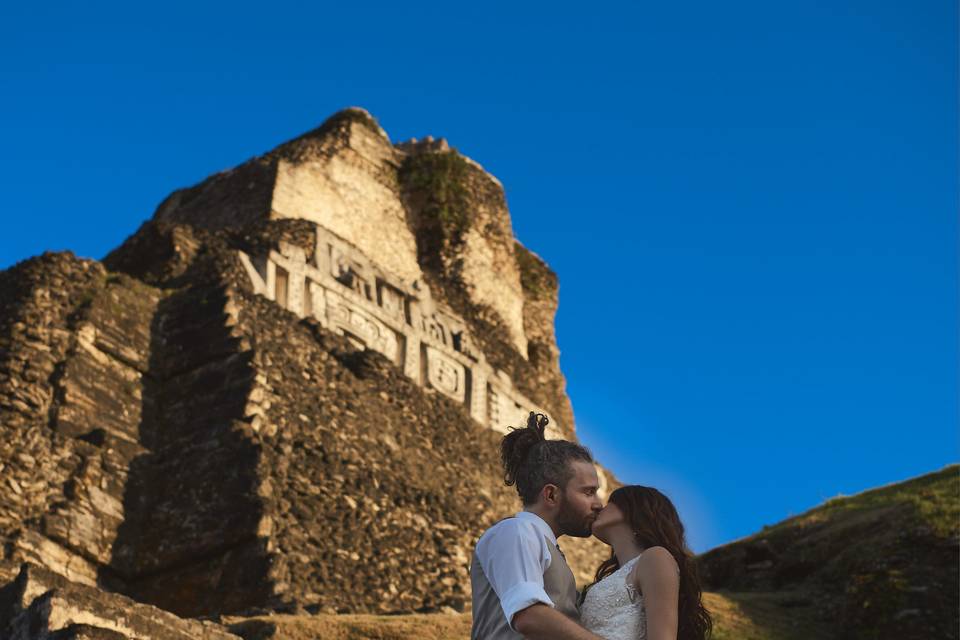 Newlyweds kissing by the steps