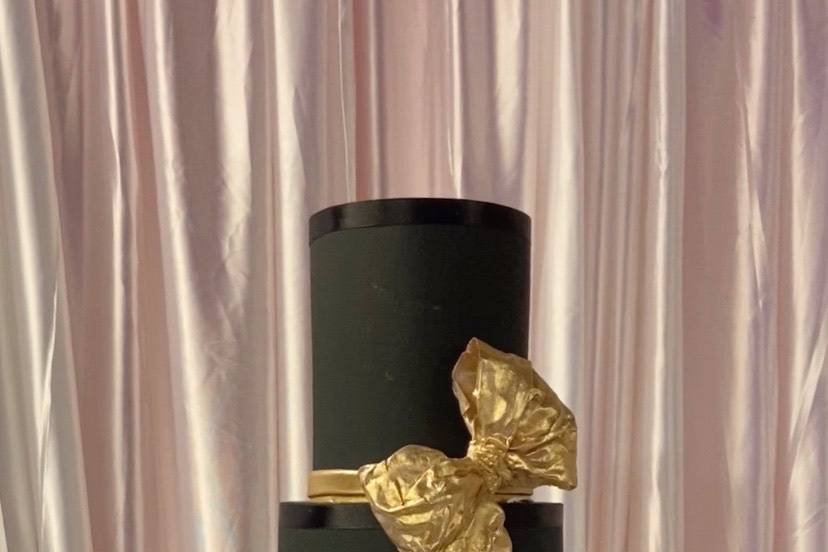 Black cake with gold bow