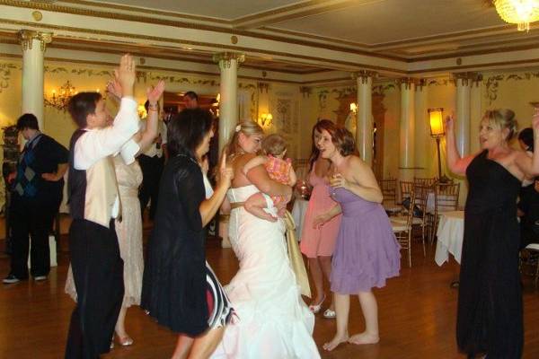 The bride and guests dancing