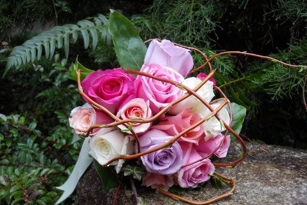 colorful roses with a curly willow cage