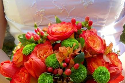 vibrant orange roses with kermit mums, tulips and alstoemerias