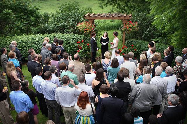 Small wedding gathering under arbor