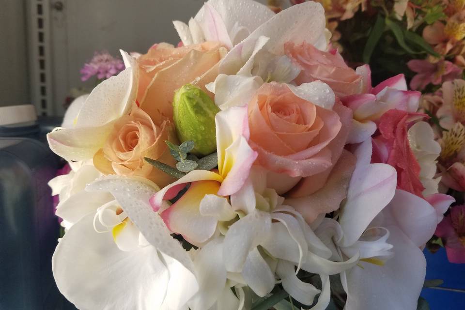 Hand tied bouquet of peach roses and white orchids