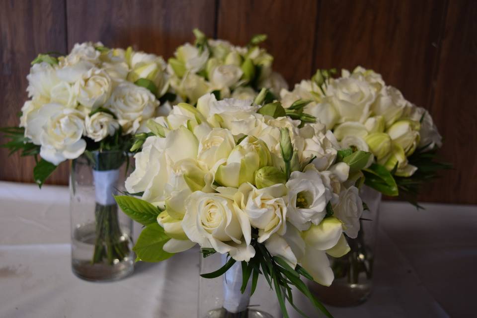 Bridal bouquet with the bridesmaids all white with accents of green.