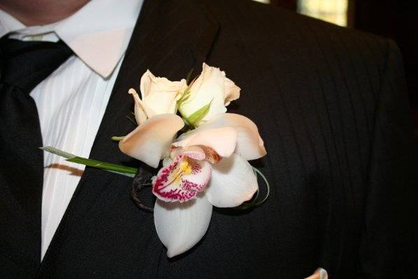 Groom's bout with an orchid and mini roses.