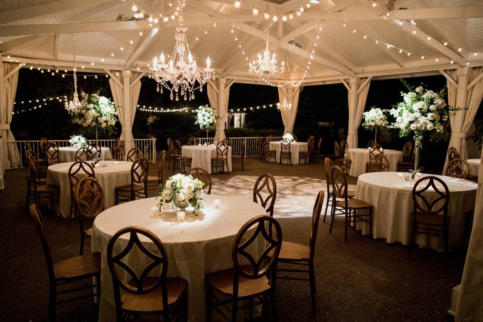 Magical chandeliers and string lights make our garden pavilion so romantic!