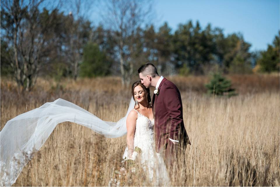 Bride and groom in a field