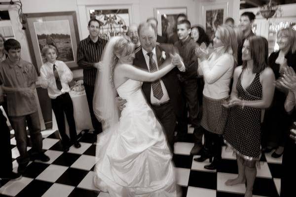 The bride and father dancing