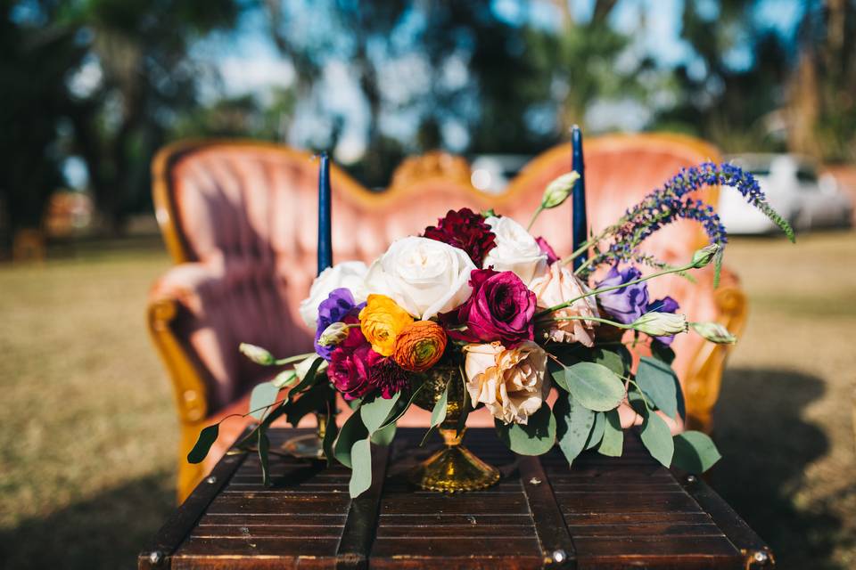 Fall color vintage centerpiece with burgundy roses and orange ranunculus