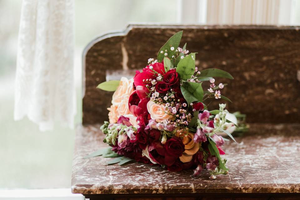 Romantic wedding bouquet burgundy roses blush roses and peonies