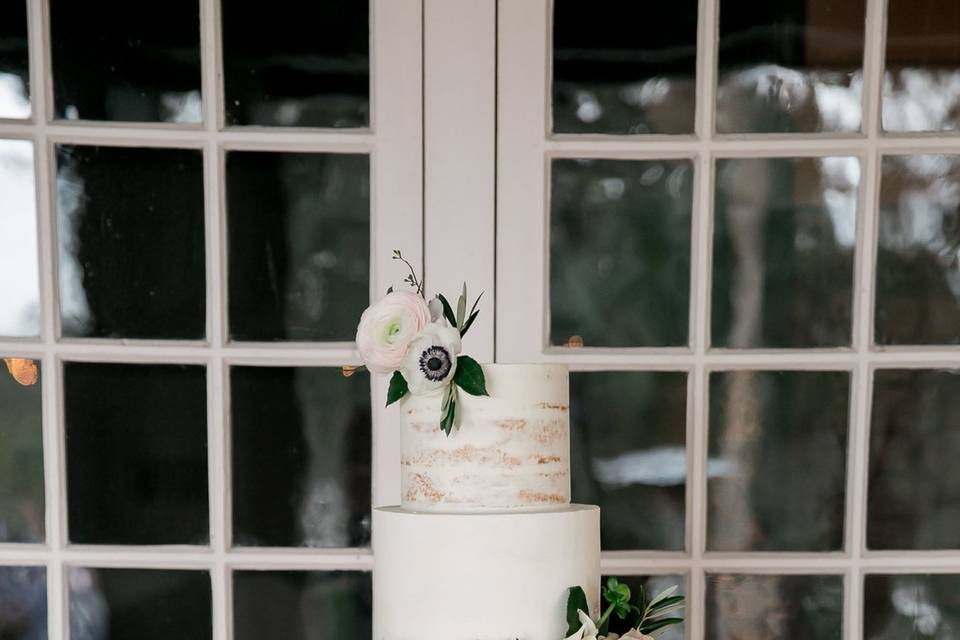 Blush roses, blush daliah flower, white anemone and olive branch greenery on white and gold wedding cake by Le petit in mount dora fl