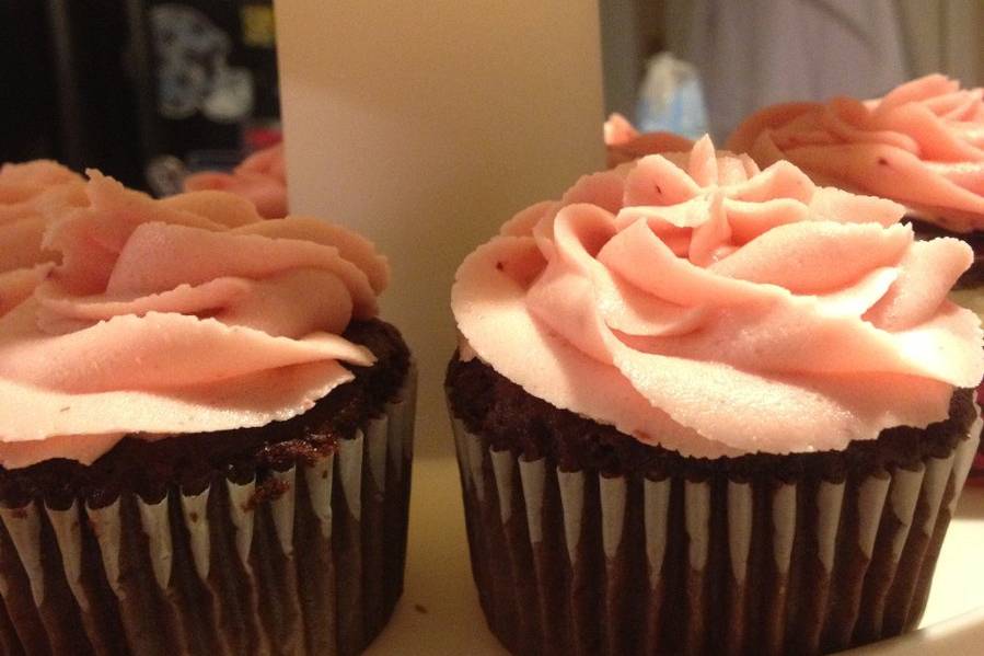 Chocolate cupcakes with strawberry icing.
