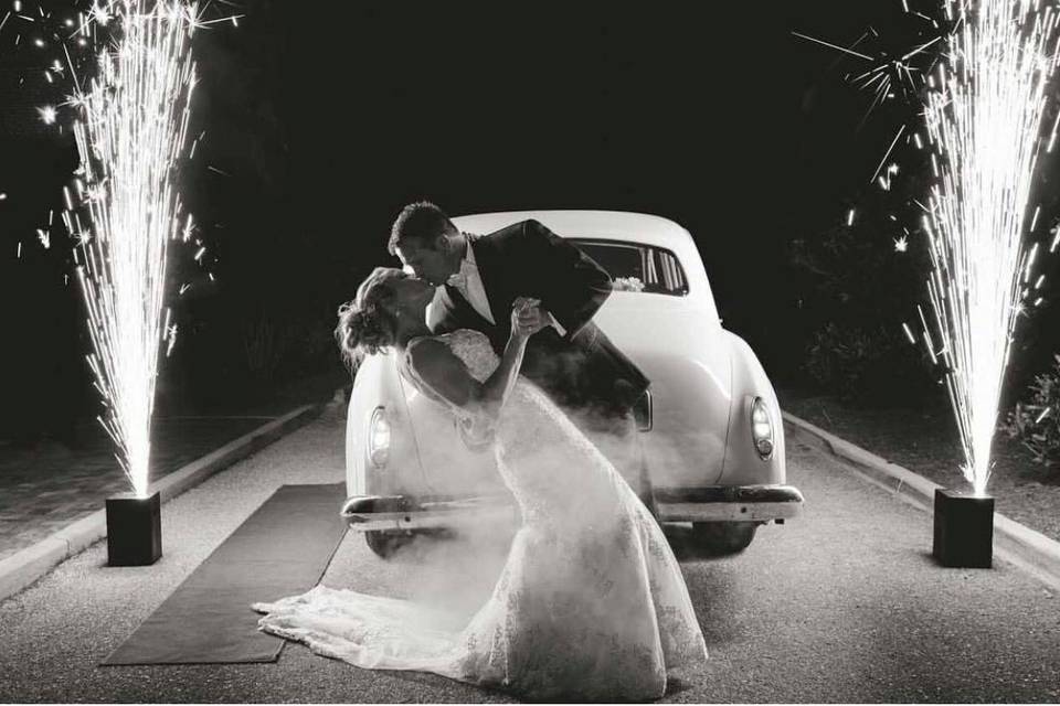 Kissing in front of vintage car