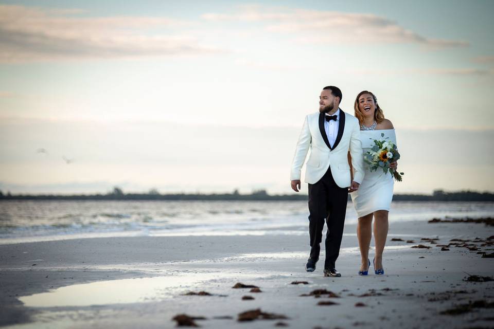 Newlyweds walking along the shore