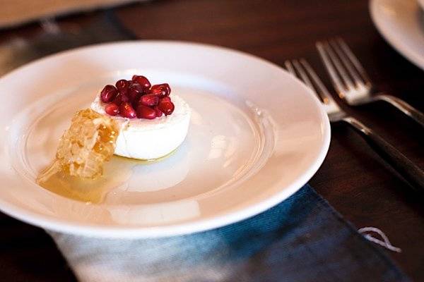 Cheese topped with pomegranate seeds.