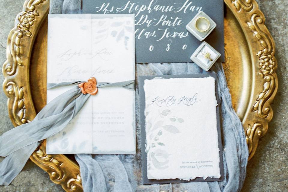 Watercolor invitation suite with calligraphy accents.