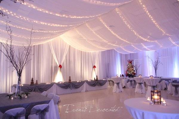 Events Decorated - Winter Wedding Reception.  Room draping, ceiling draping, twinkle lighting, up lighting, table linens, chair covers and sashes, floral centerpieces, and atmosphere decor.