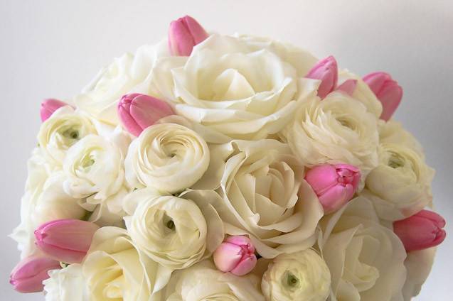 Predominantly white bouquet with touches of light pink tulips. A very sweet romantic and sweet combination.