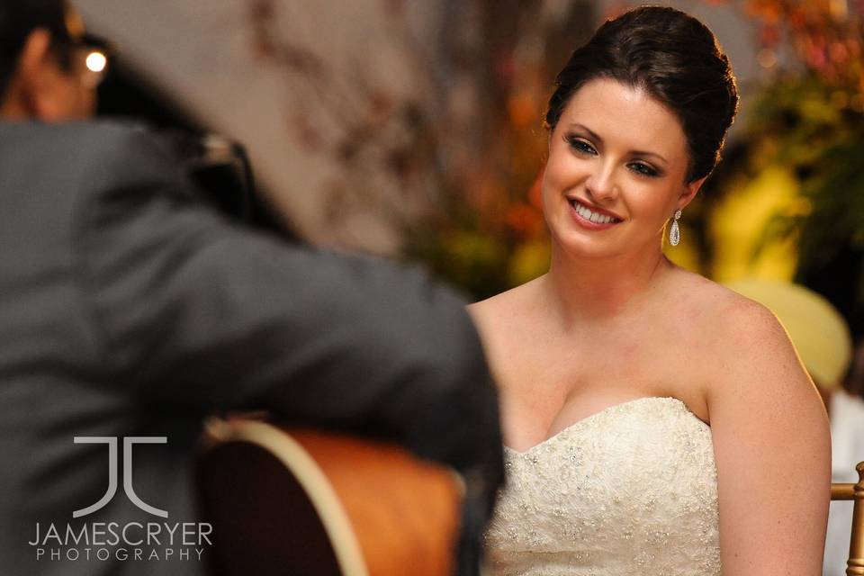 A groom's surprise serenade for his beautiful bride.  These are the special moments that are remembered forever through professional photography.