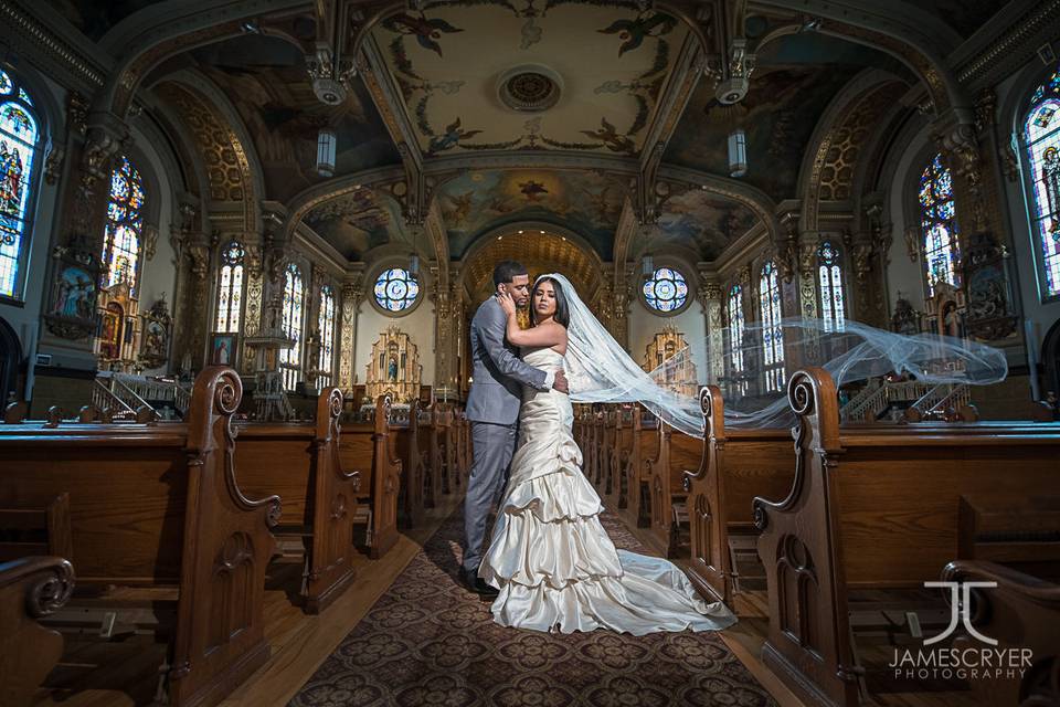 The amazing architecture of Holy Trinity Polish Catholic Church in Chicago helps to make this amazing wedding photo absolutely timeless.